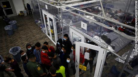 Young minors talk to an agent at the Donna Department of Homeland Security holding facility in the Rio Grande Valley, March 30, 2021. 