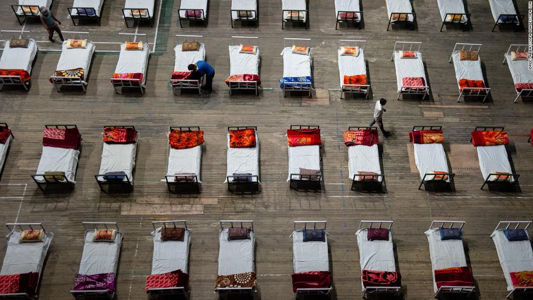 Workers prepare beds for a Covid-19 isolation center that was set up inside a stadium in Srinagar on April 27. 