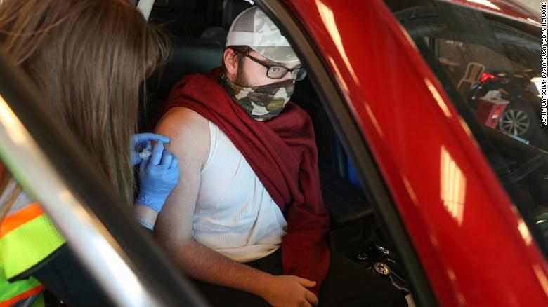 A pharmacy resident gives a Johnson &amp; Johnson Covid-19 vaccine at the Indianapolis Motor Speedway on April 25, 2021