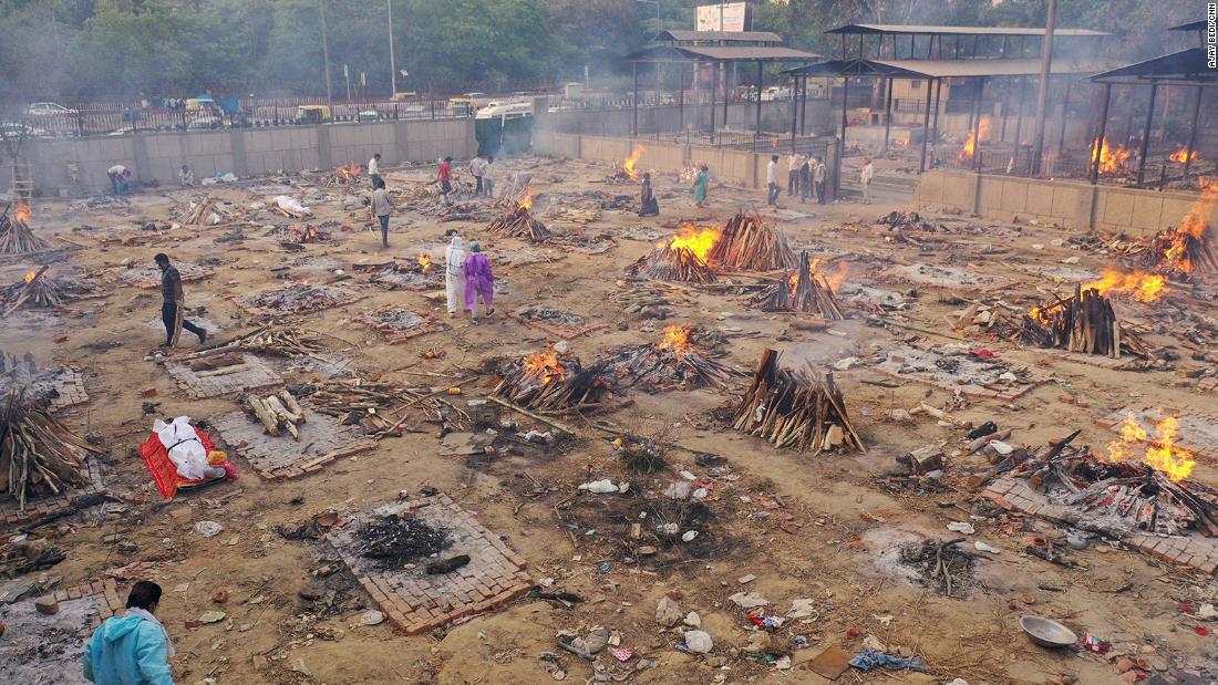 As India's crematoriums overflow with Covid victims, pyres burn through the night