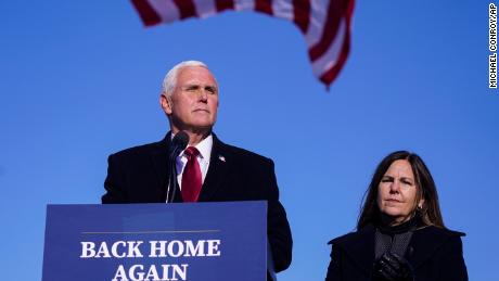 On January 20, 2021, former Vice President Mike Pence speaks after arriving back in his hometown of Columbus, Indiana, as his wife Karen watches.