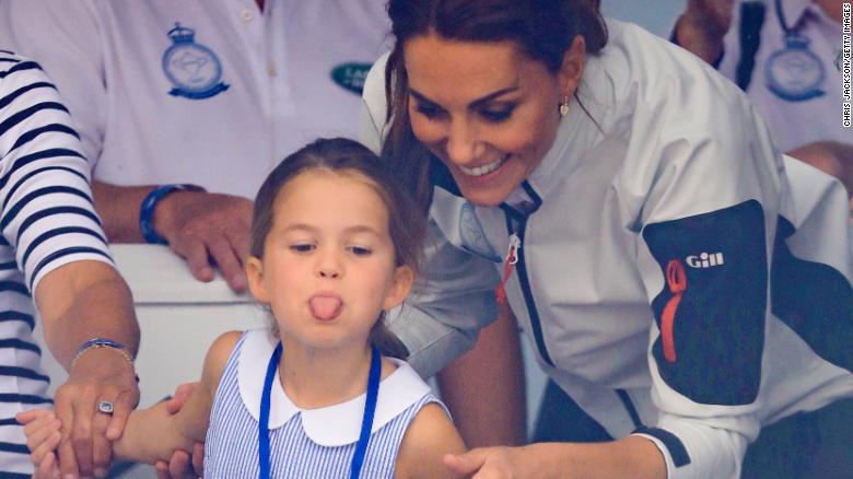 Princess Charlotte playfully sticks out her tongue while attending a King&#39;s Cup regatta with her mother, right, in 2019.