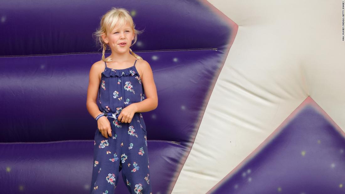 Isla Phillips, Savannah&#39;s sister, plays on an inflatable slide during a festival in 2018.