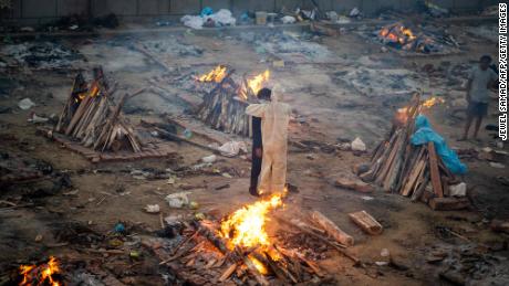 Family members embrace each other at a cremation ground in New Delhi, India, on April 26.