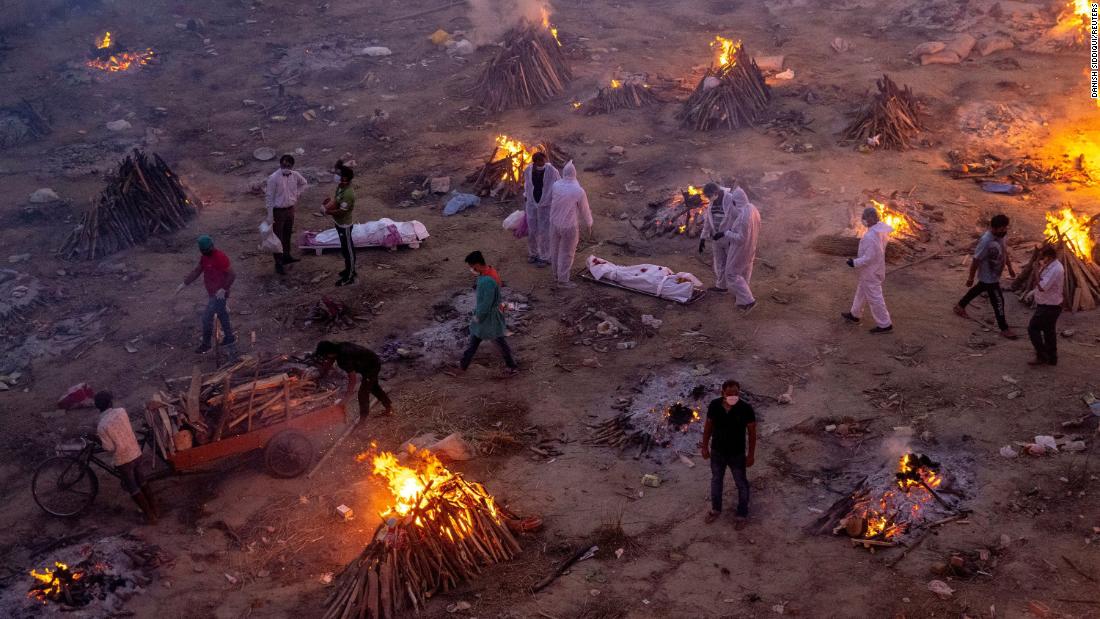 Funeral pyres burn in New Delhi as people wait to cremate Covid-19 victims on April 23. A second wave of Covid-19 &lt;a href=&quot;http://www.cnn.com/2021/04/26/india/gallery/india-coronavirus-crisis/index.html&quot; target=&quot;_blank&quot;&gt;is devastating India,&lt;/a&gt; killing thousands of people each day and setting world records for daily infections.