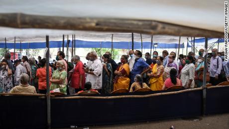 People line up to receive Covid-19 vaccines at a mass vaccination center on April 29 in Mumbai, India.