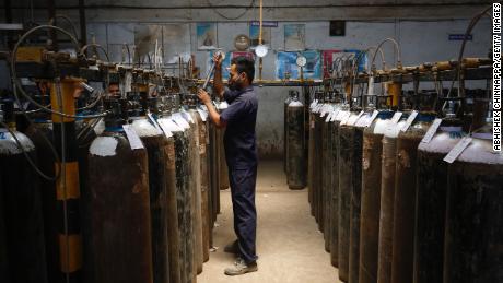 An employee fills oxygen cylinders inside an oxygen filling centre on April 28, 2021 in Bengaluru, India.