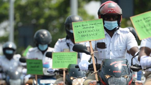 Police personnel hold placards on their motorbikes during a Covid-19 awareness rally in Chennai on April 29.
