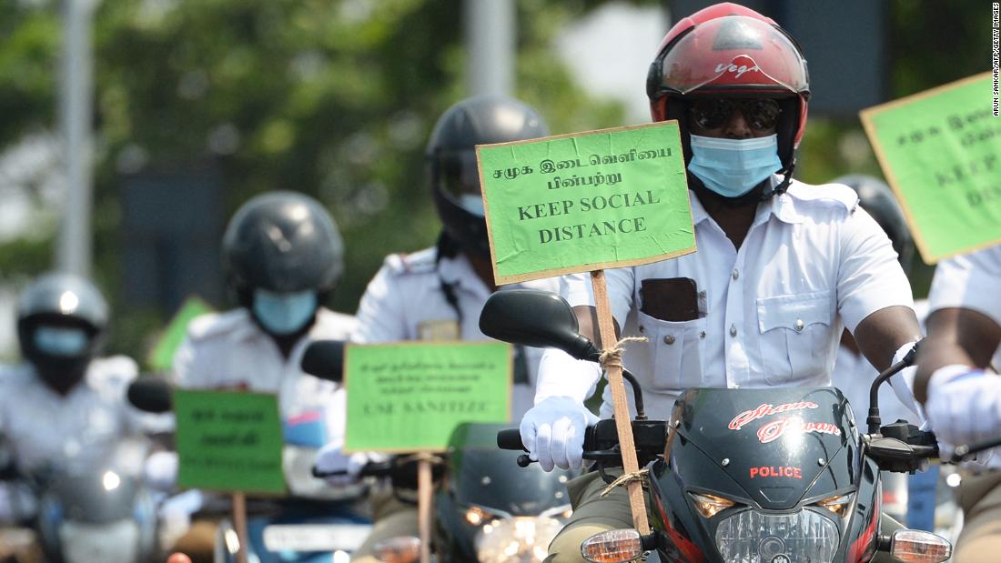 Police personnel hold placards on their motorbikes during a Covid-19 awareness rally in Chennai on April 29.