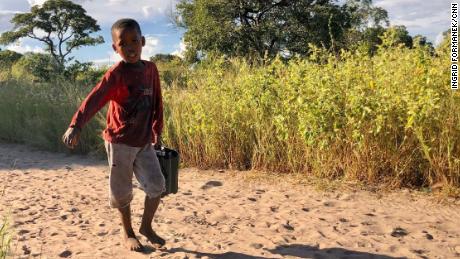 In the San village, children carry water from a nearby borehole. Activists and scientists fear that a large-scale oil industry here could pollute the ground water. ReconAfrica says their practices won&#39;t lead to water pollution.