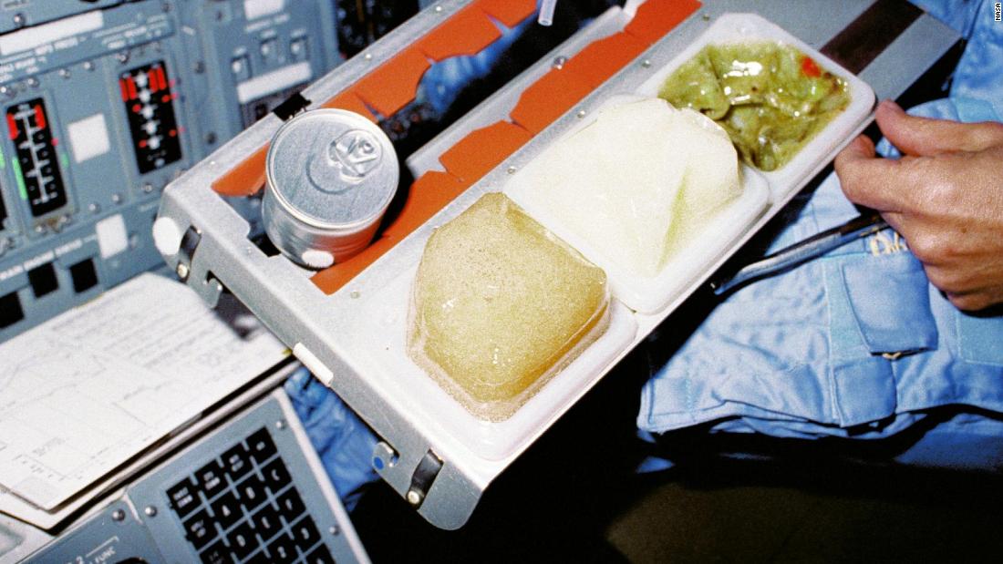 STS-9 was the space shuttle Columbia&#39;s sixth spaceflight, but it was the first opportunity for an onboard galley, located in the middeck. The metal tray made for easy prep and serving of in-space meals. This crew member is seated at the pilot&#39;s station on the flight deck in late 1983.