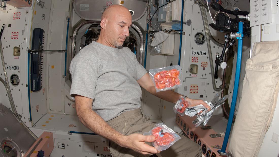 European Space Agency astronaut Luca Parmitano, Expedition 36 flight engineer, is pictured near food packages floating freely in the Unity module of the International Space Station, June 24, 2013.