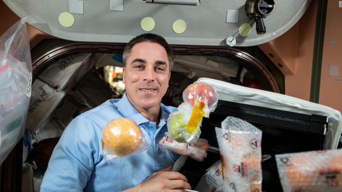 NASA astronaut and Expedition 63 Commander Chris Cassidy unpacks fresh fruit and other food items shipped aboard the Northrop Grumman Cygnus space freighter to the International Space Station, October 5, 2020.