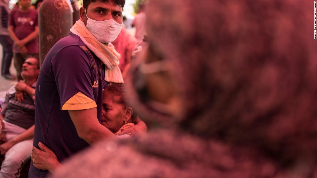 A woman hugs her son after arriving to receive free oxygen in New Delhi on May 1.