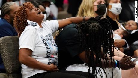 Family members react during Brown&#39;s funeral on Monday.