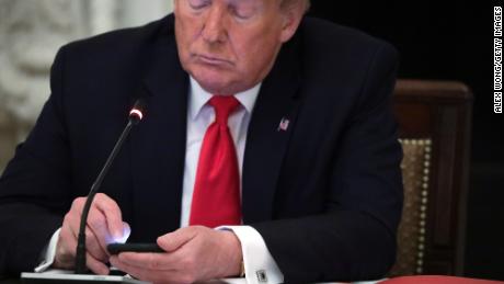 U.S. President Donald Trump works on his phone during a roundtable at the State Dining Room of the White House June 18, 2020 in Washington, DC. President Trump held a roundtable discussion with Governors and small business owners on the reopening of American&#39;s small business. (Photo by Alex Wong/Getty Images)