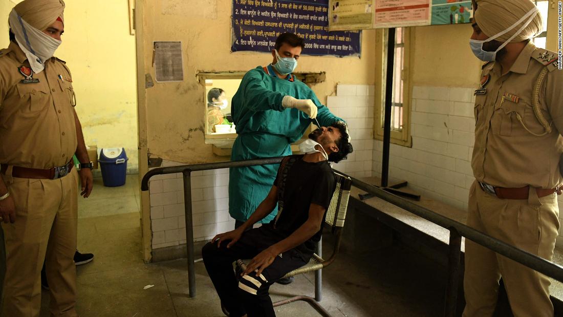 A health worker administers a Covid-19 test on the outskirts of Amritsar on May 3. Police in rural areas launched a free cab service for villagers so they could get tested and vaccinated.