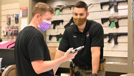 A prospective customer inspects a handgun at Maxon Shooter&#39;s Supplies &amp; Indoor Range in Des Plaines, Illinois. 