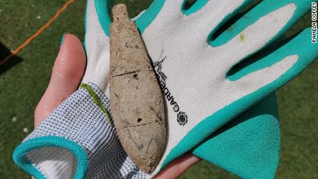 Pamela Coffey holds the object she found while working in the yard.