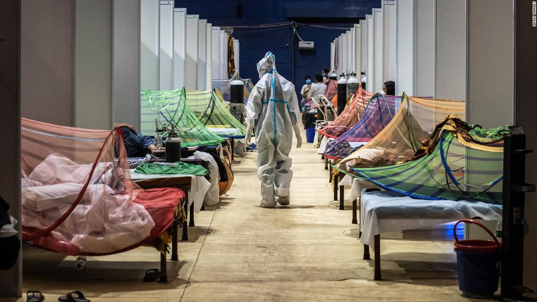 A medical worker observes patients inside a Covid-19 ward that was set up inside a sports stadium in New Delhi.