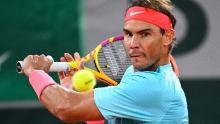 Nadal returns the ball to Novak Djokovic during their men's final tennis match at the 2020 French Open.