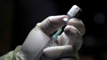 A healthcare worker prepares to administer a Pfizer/BioNTEch coronavirus disease (Covid-19) vaccine at The Michener Institute, in Toronto, Ontario on December 14, 2020. - Ontario, Canada&#39;s most populous province and one of the hardest hit by the pandemic, had 1,940 new cases and 23 deaths on Monday.  The province is expected to give its next doses to nursing home workers as a priority, according to media reports. (Photo by CARLOS OSORIO / POOL / AFP) (Photo by CARLOS OSORIO/POOL/AFP via Getty Images)