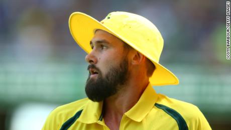 Kane Richardson of Australia looks on wearing a yellow floppy hat during game three of the One Day International Series between Australia and India at the Melbourne Cricket Ground on January 17, 2016 in Melbourne, Australia. 