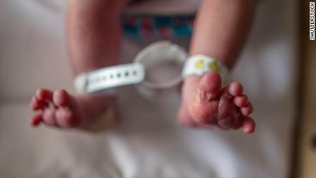 Newborn baby feet and toes in bassinet in hospital