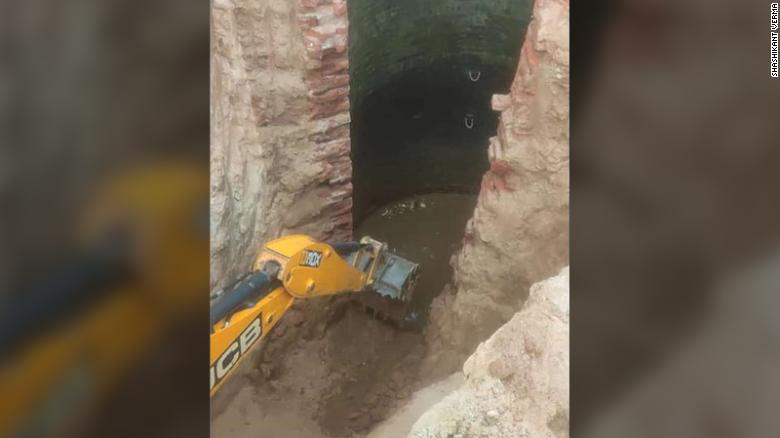 Multiple backhoes were used to demolish the side of the well and excavate a trench for the elephant to walk out on.