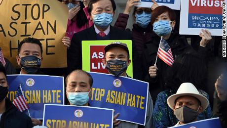 People hold signs during a &quot;Rally Against Discrimination, Hate and Violence&quot; in support of people of Asian descent, held on the steps of Brooklyn Borough Hall in New York in March.