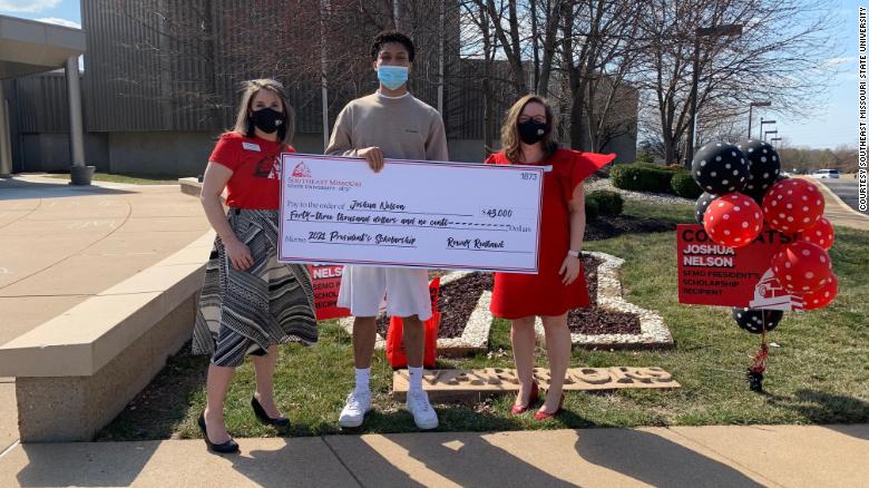 18-year-old Joshua Nelson standing with Katie Krodinger and Lenell Hahn, shows off the scholarship given to him by Southeast Missouri State University.