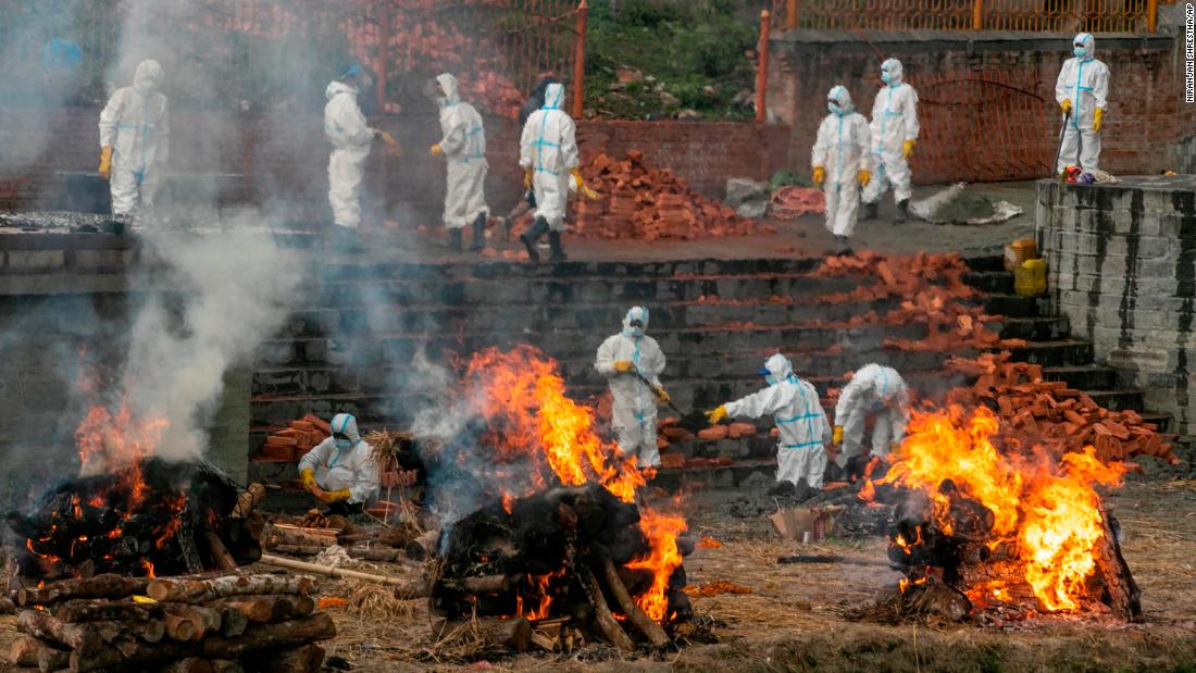 People in protective suits cremate the bodies of Covid-19 victims while others work to extend a crematorium in Kathmandu, Nepal, on May 5. &lt;a href=&quot;https://edition.cnn.com/2021/05/06/asia/nepal-covid-outbreak-intl-hnk-dst/index.html&quot; target=&quot;_blank&quot;&gt;Covid-19 cases are skyrocketing in Nepal,&lt;/a&gt; resembling a similar outbreak in neighboring India.