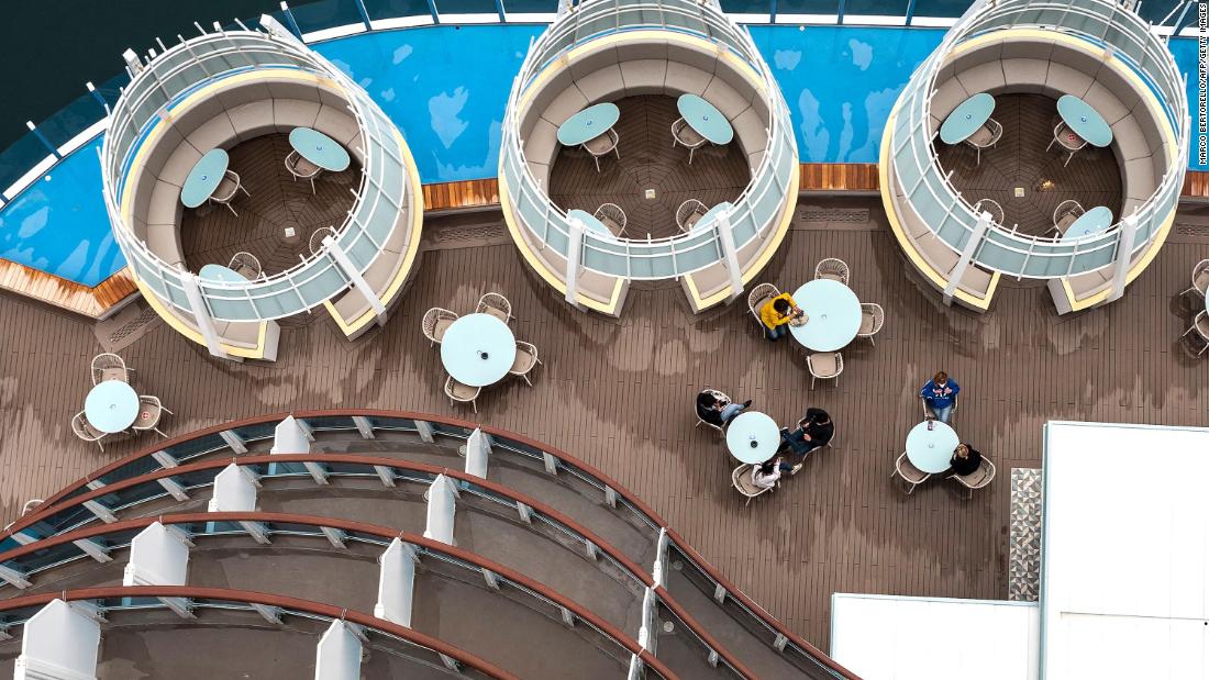 Passengers sit on the deck of the Costa Smeralda cruise ship in Savona, Italy, on May 1. The Italian cruise line Costa Cruises set sail for the first time in more than four months.