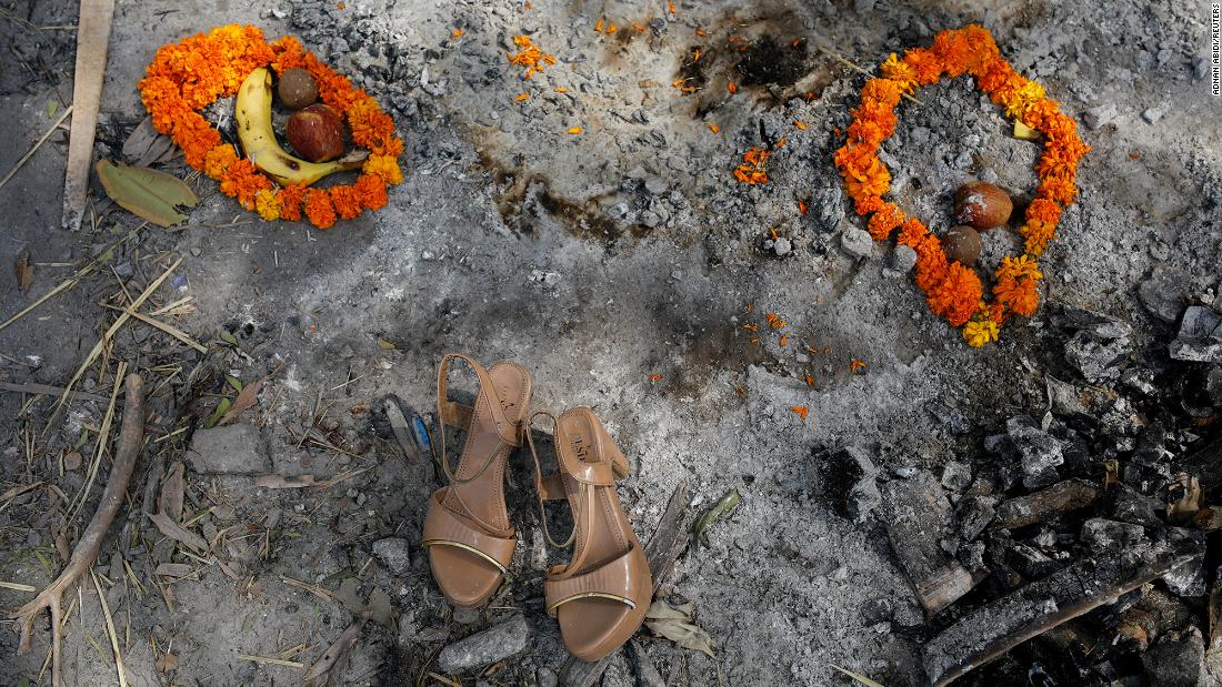 Flower garlands, fruits and a pair of sandals were placed on a spot where a woman was cremated in New Delhi on April 30. 