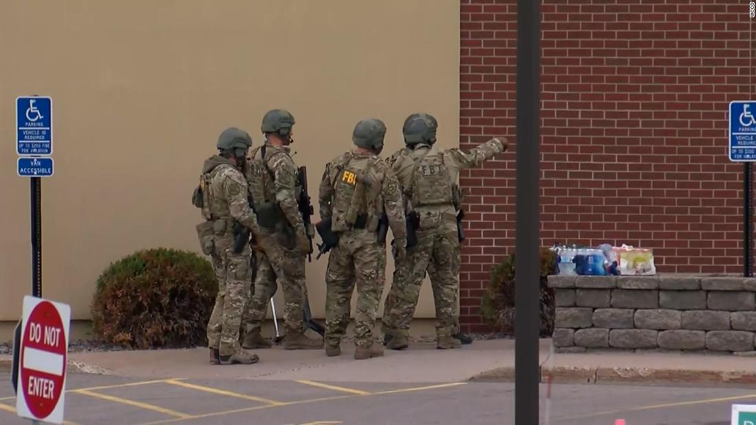 A suspect has been arrested and hostages released after an eight-hour standoff at a Minnesota bank, police say