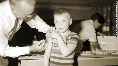 A doctor gives a measles vaccination to a boy in 1962 at Fernbank School in Atlanta. 