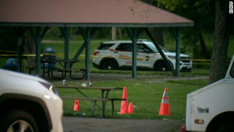 Police at the scene of Friday&#39;s shooting at a park in Kinloch, Missouri. 