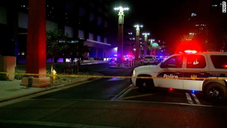 Police vehicles attend the scene of a fatal shooting in downtown Phoenix.