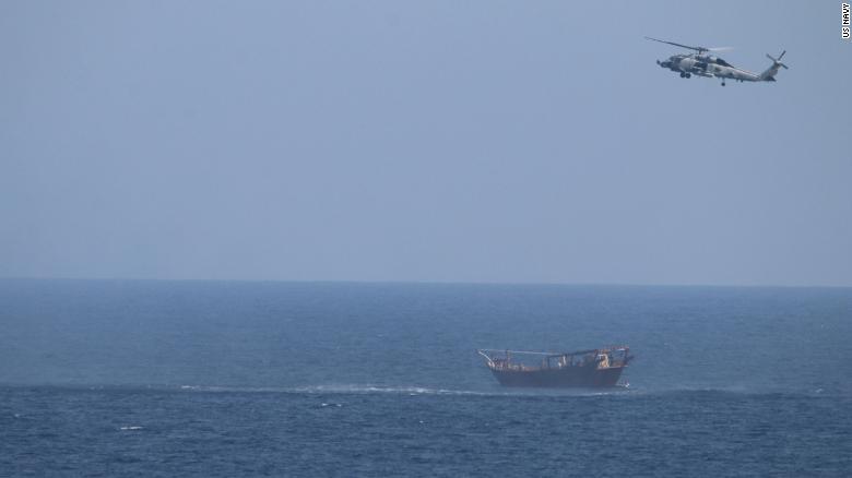 An SH-60 Sea Hawk helicopter assigned to the guided-missile cruiser USS Monterey flies above a stateless dhow interdicted with a shipment of illicit weapons in international waters of the North Arabian Sea on May 6, 2021.