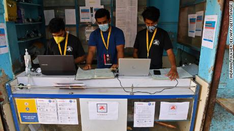 Shahnawaz Shaikh (C), manages data in his operating center that was previously a general store in Mumbai on April 28, 2021.