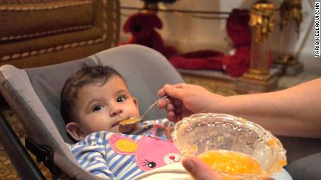 Khadija feeds her 5-month old daughter, Lamees. 