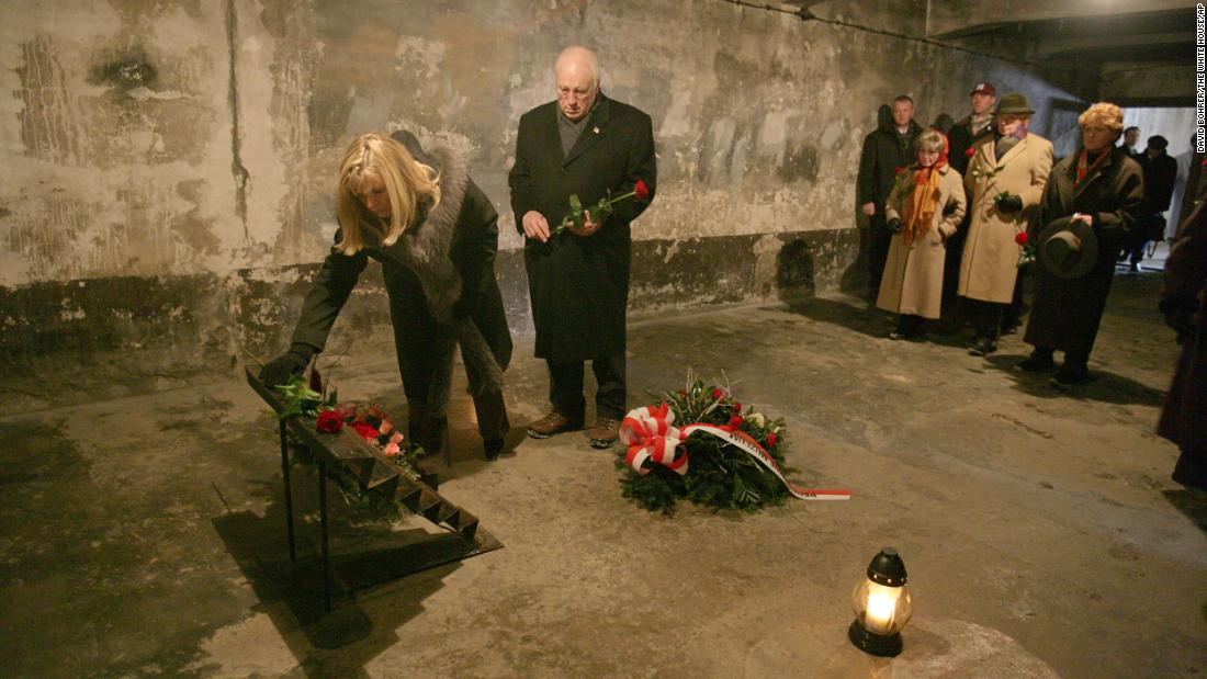 Cheney and her father lay flowers at an Auschwitz memorial near Krakow, Poland, in 2005.