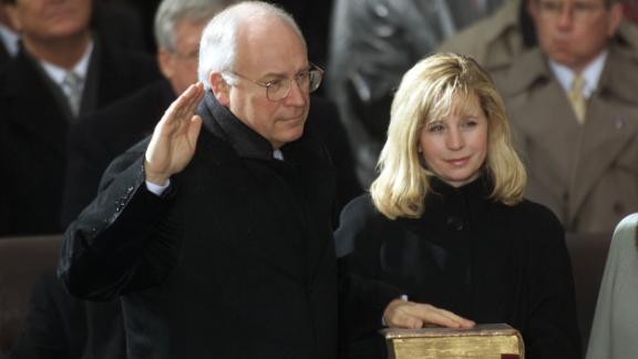 Liz Cheney holds the Bible for her father as he's sworn in as vice president in 2001.