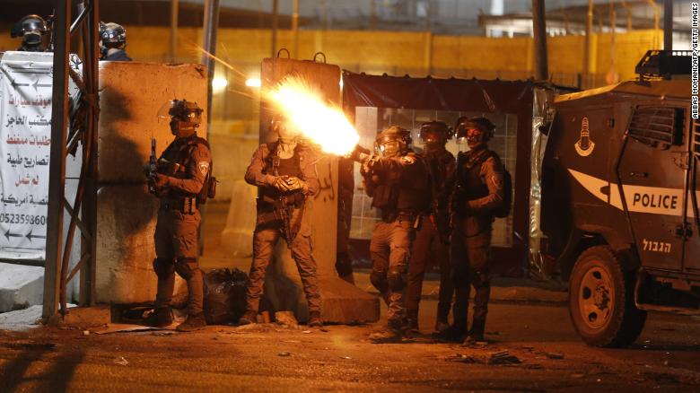 IDF soldiers fire tear gas at Palestinian demonstrators at the Qalandiya checkpoint between Ramallah and Jerusalem, in the West Bank on Tuesday.