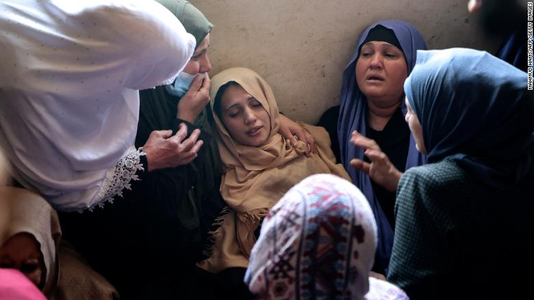 The mother of Palestinian Hussien Hamad, 11, is comforted by mourners during his funeral in Beit Hanoun in the northern Gaza Strip on Tuesday.