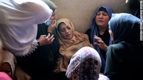 The mother of Palestinian Hussien Hamad, 11, is comforted by mourners during his funeral in Beit Hanoun in the northern Gaza Strip on Tuesday.