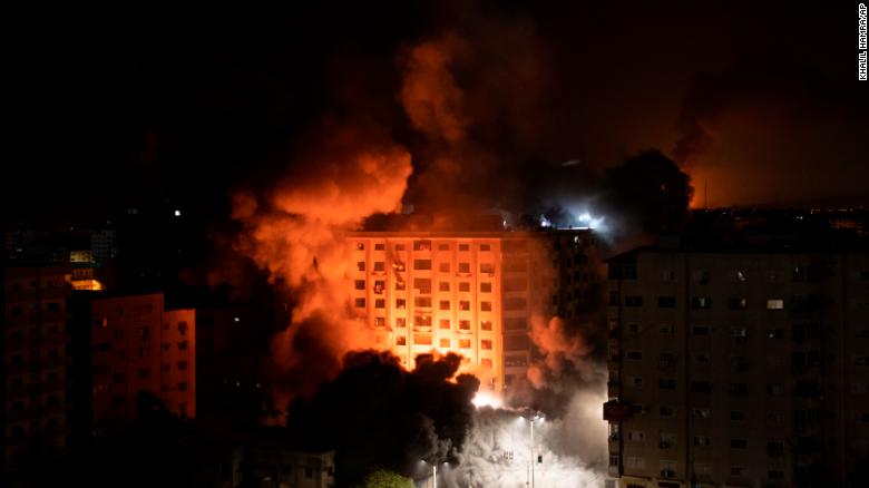 Smoke caused by Israeli airstrikes are seen at a residential building in Gaza City.