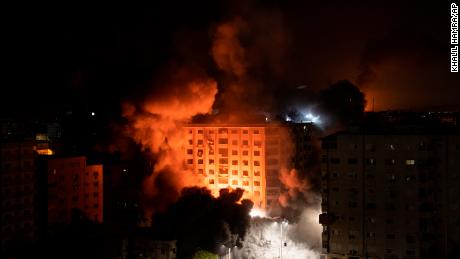 Smoke caused by Israeli airstrikes are seen at a residential building in Gaza City.