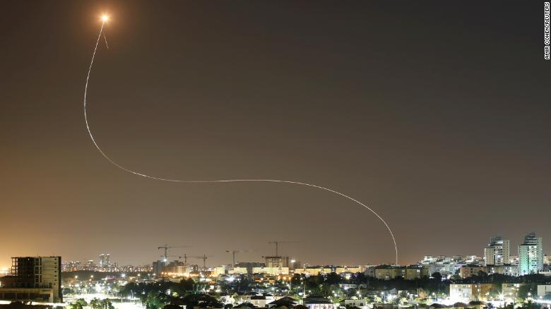 A streak of light is seen from Ashkelon, Israel, as Israel&#39;s Iron Dome system intercepts rockets launched from Gaza on May 11.
