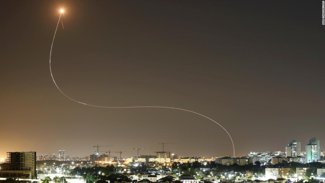 A streak of light is seen from Ashkelon, Israel, as Israel&#39;s Iron Dome anti-missile system intercepts rockets launched from Gaza on May 11.